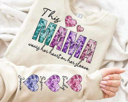 This Mama Wears Her Heart Personalized Hoodie – Custom Mama Hoodie with Kids’ Names on Sleeve – Mother’s Day Gift, Cool Mom Hoodie, Birthday Gift for Mom, Valentine’s Day Gift